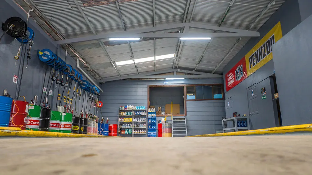 Interior del taller con carretes de lubricación y barriles Castrol